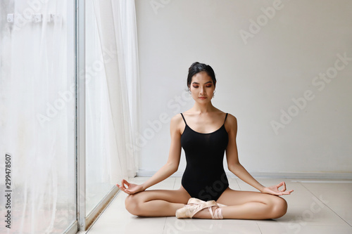 beautiful healthy asian woman in ballet dress enjoying in meditates with yoga pose at home with relaxation