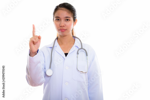 Portrait of young Asian woman doctor against white background