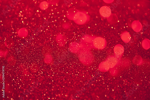 Abstract defocused circular red luxury gold glitter bokeh lights background.