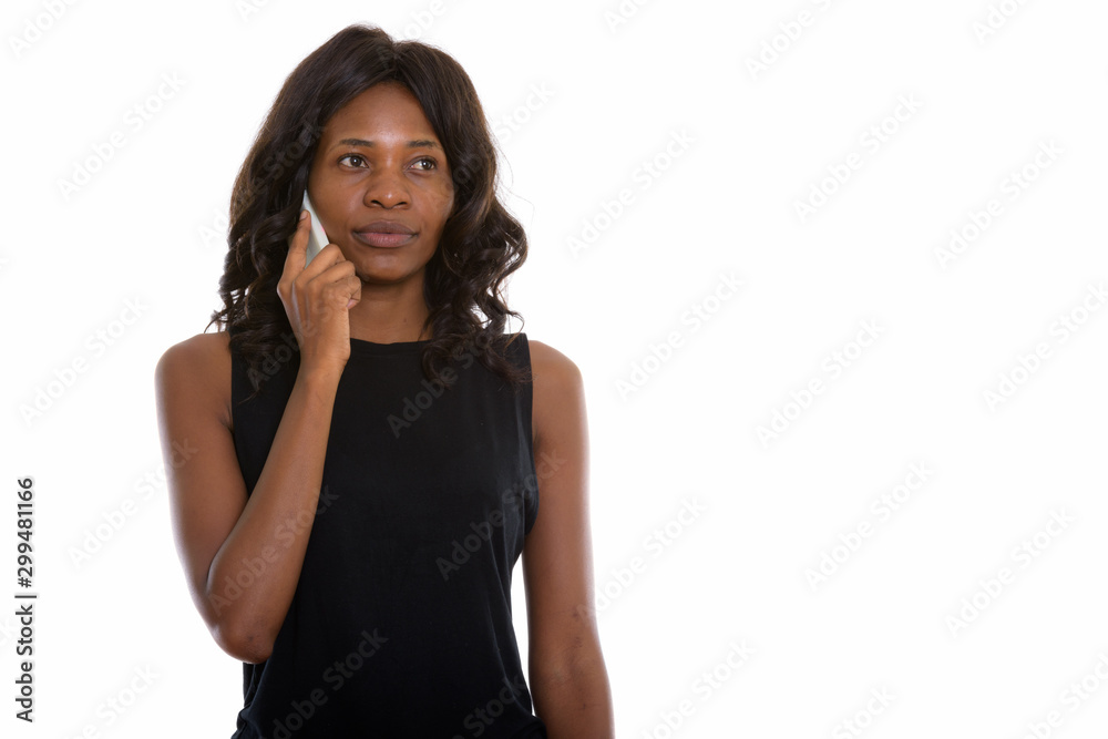 Studio shot of young beautiful African woman using phone Studio shot of young beautiful African woman using phone