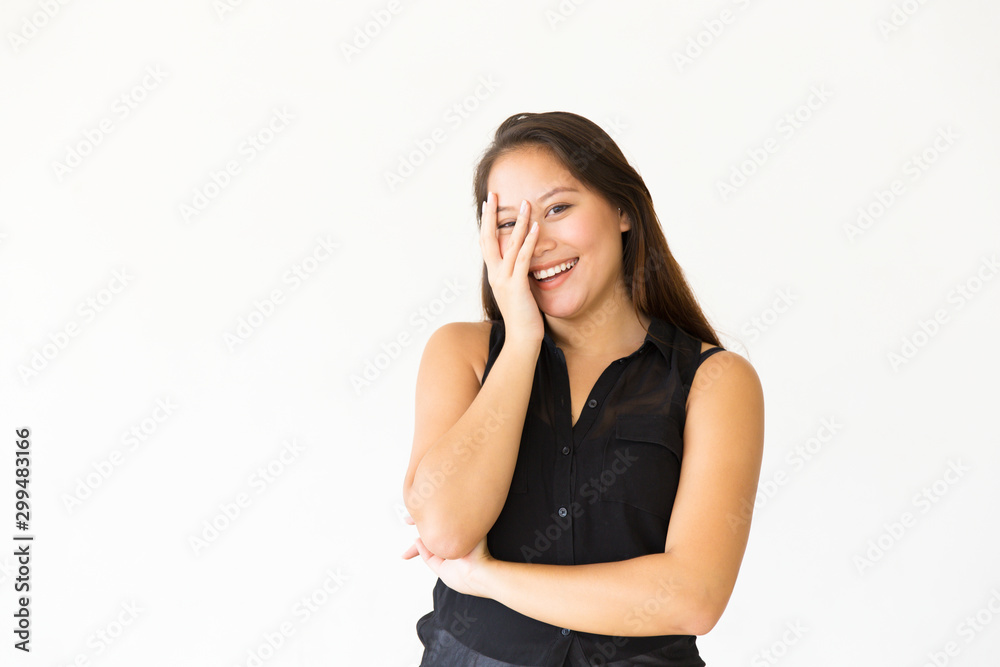Happy joyful teenage girl touching face with palm, laughing. Young Latin woman in casual standing isolated over white background. Having fun concept Happy joyful teenage girl touching face with palm, laughing. Young Latin woman in casual standing isolated over white background. Having fun concept