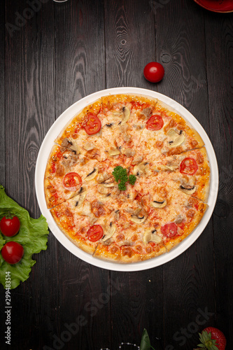 assorted pizza sliced into pieces with cheese, tomato and olives
