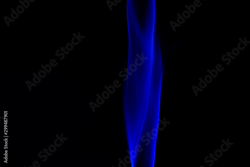 blue smoke from aromatic sticks on a black background