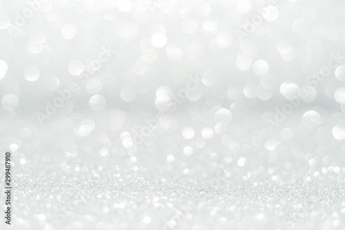 Silver Sparkling Lights Festive background with texture. Abstract Christmas twinkled bright bokeh defocused and Falling stars. Winter Card or invitation	