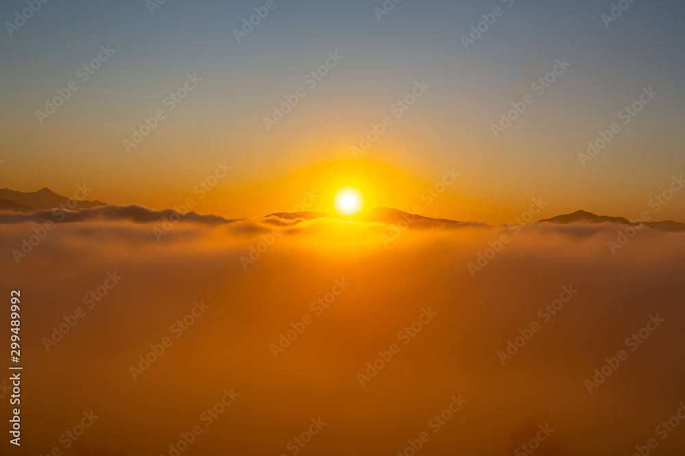 A dramatic view of beautiful sunrise with sea of clouds from top of the Mountain, South Korea.