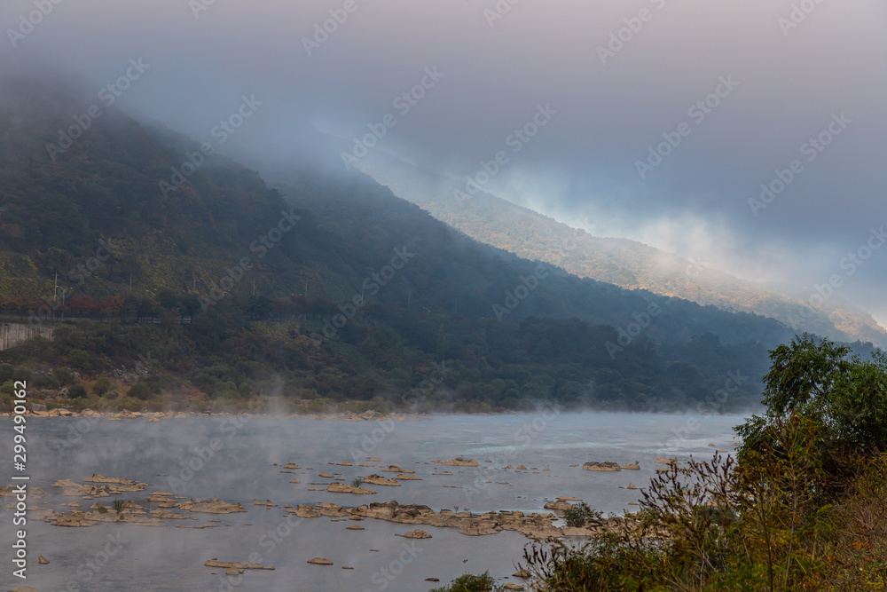 A landscape view of stream with rising wet fog in the morning, South Korea.