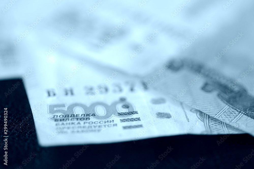 Russian banknotes of five thousand rubles close-up. Money background blue color toned Russian banknotes of five thousand rubles close-up. Money background blue color toned