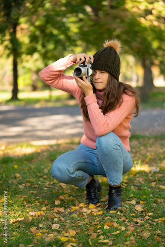 Girl taking a photo with camera. © Jasmina