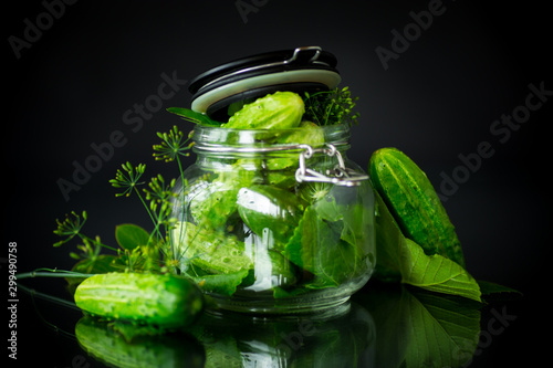 cucumbers and spices with herbs for canning in a jar