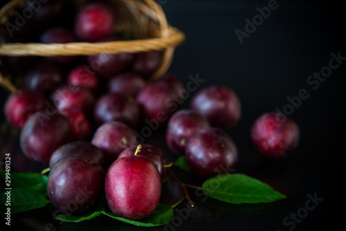 organic red ripe cherry plum isolated on black