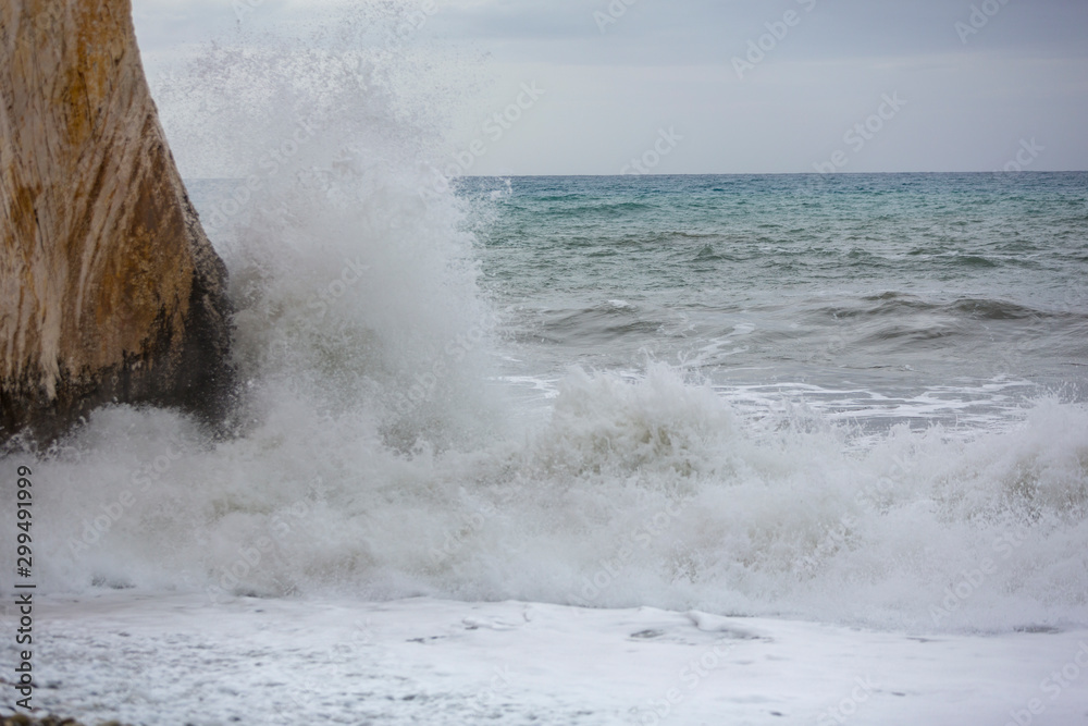 Wave splashes against Aphrodite's Rock, Cyprus.
