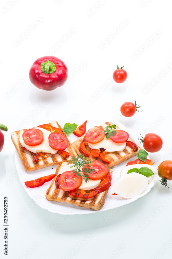 Closeup of a fresh sandwich with mozzarella, tomatoes Closeup of a fresh sandwich with mozzarella, tomatoes