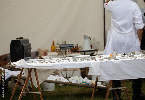 Antique Surgical Instruments and rear view of a doctor photo