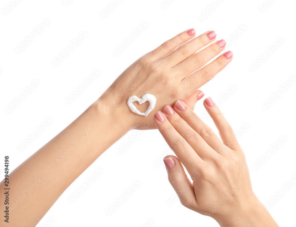 Heart made with cream on hand of young woman against white background Heart made with cream on hand of young woman against white background