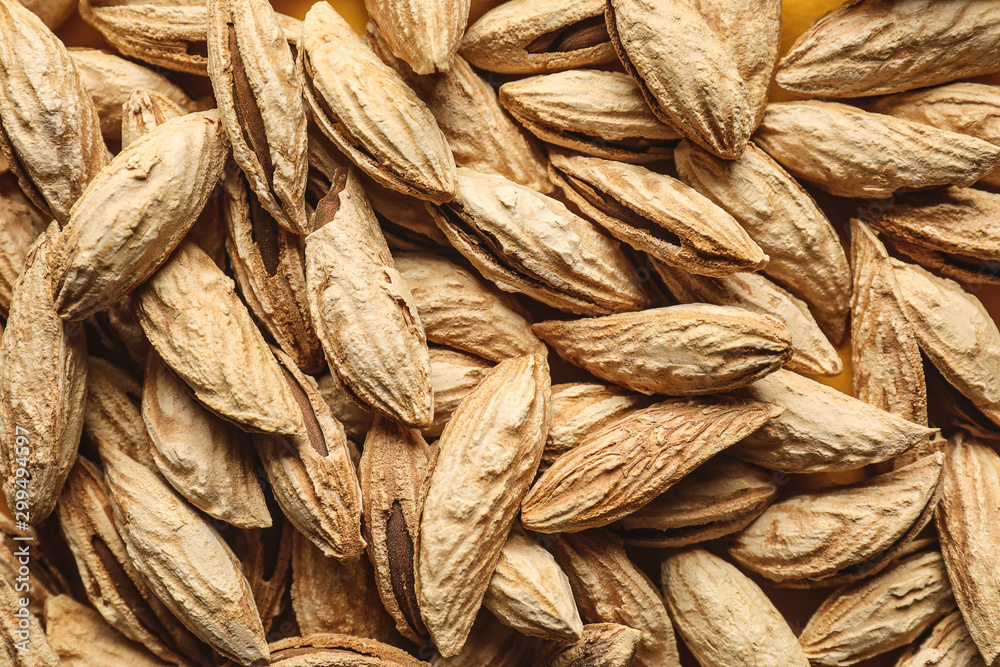 Many unpeeled almonds as background Many unpeeled almonds as background
