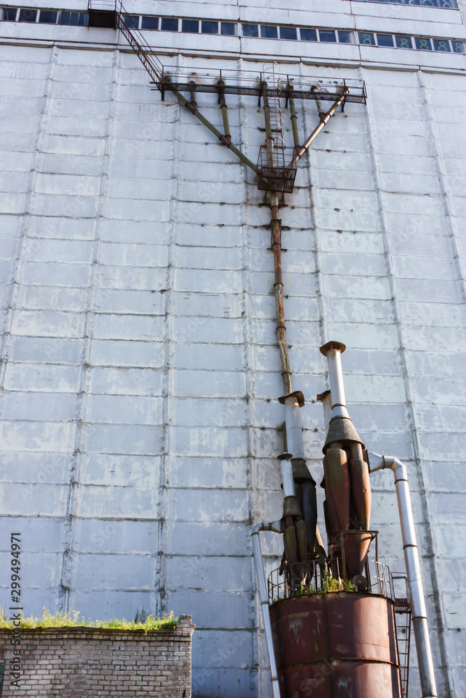 metal structures on the wall of an old abandoned industrial plant, selective focus metal structures on the wall of an old abandoned industrial plant, selective focus