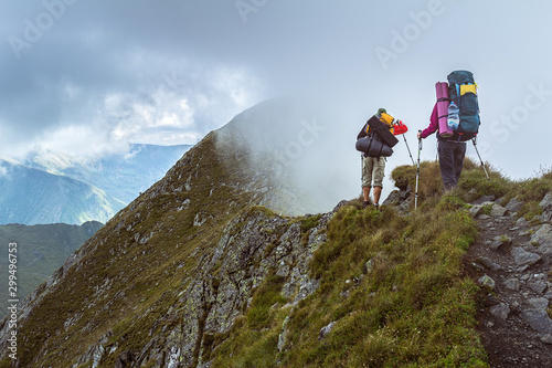 Hikers goes along a steep mountain ridge, Romanian Carpathians, Fagerash array photo