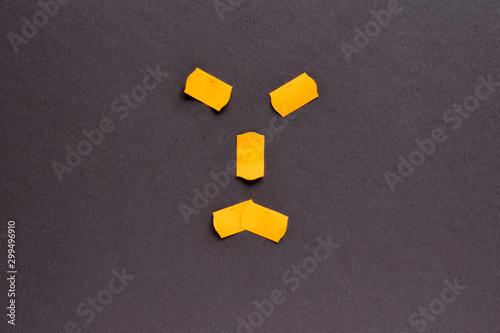 Orange stickers and price tags on a dark gray paper background