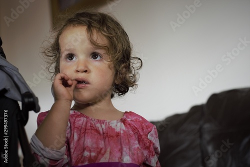 little girl tatching her tooth photo