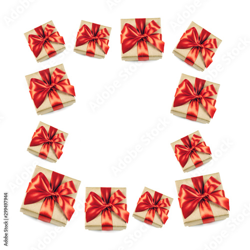 Frame of festive gift boxes with red ribbon bow isolated on white background.