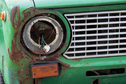 Broken headlight of an old abandoned russian car