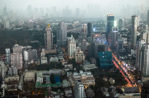Top view of the streets of Bangkok s business district in the evening in foggy weather. Skyscrapers in the fog. Traffic jam on the street in the business district of Bangkok  Thailand.