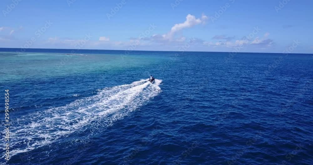 The Fast Jet Ski Dashing into the Vast Depth Ocean with Green Trees and Houses Nearby in the Island of Philippines - Wide Shot 4K The Fast Jet Ski Dashing into the Vast Depth Ocean with Green Trees and Houses Nearby in the Island of Philippines - Wide Shot 4K