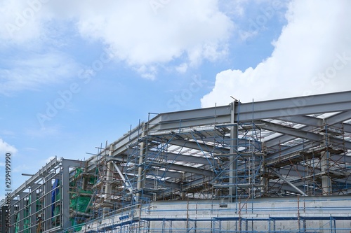 The structure of building with blue sky and clound as a background, Steel construction in large construction site, Space for text in template