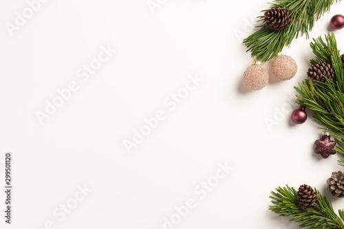 Christmas composition. Spruce branches with cones and christmas decorations, on a white background. Flat lay, top view, copy space.