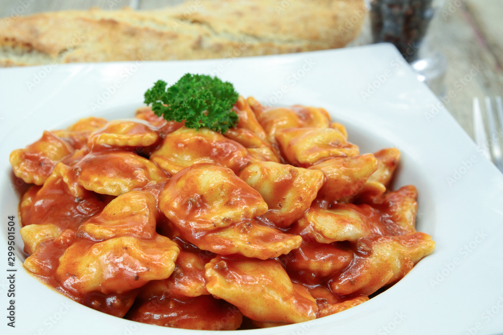 plate of canned ravioli on a wooden table plate of canned ravioli on a wooden table