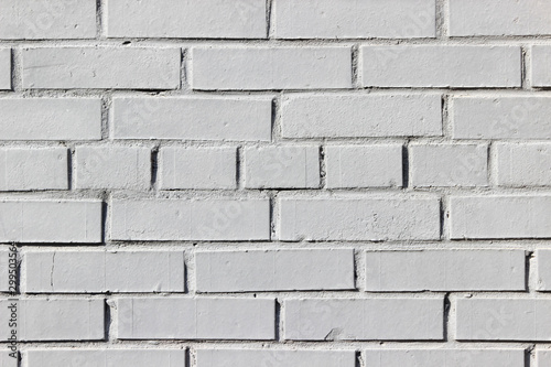 Texture of an old brick wall painted in white