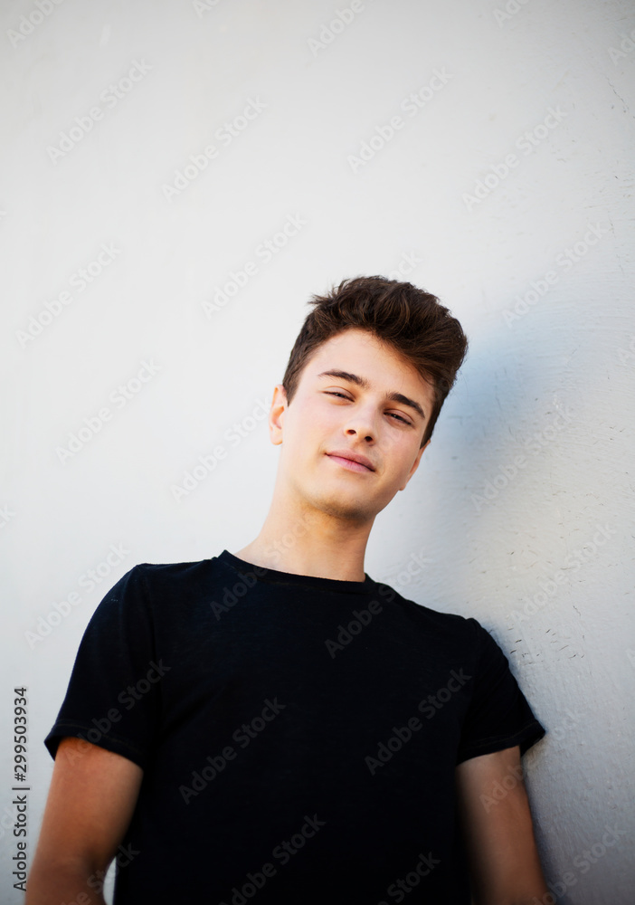 Young attractive man posing in front of camera in a black t-shirt Young attractive man posing in front of camera in a black t-shirt