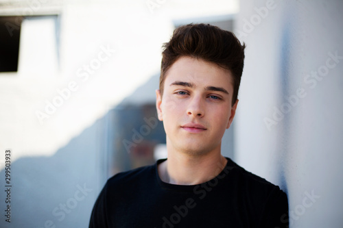 Young attractive man posing in front of camera in a black t-shirt