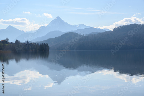 Fototapeta Naklejka Na Ścianę i Meble -  weissensee, idyllic lake in dusty morning light front of the blue mountains of the bavarian alps near füssen in the allgäu, germany, copy space