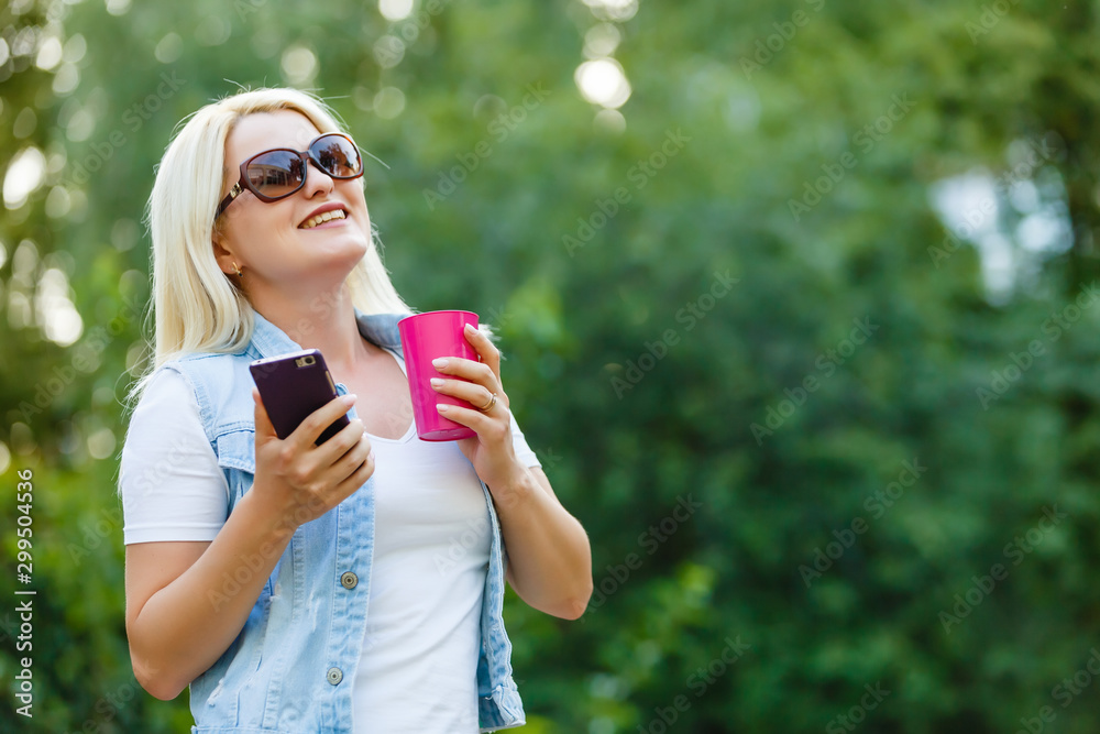 Smiling woman with a smartphone