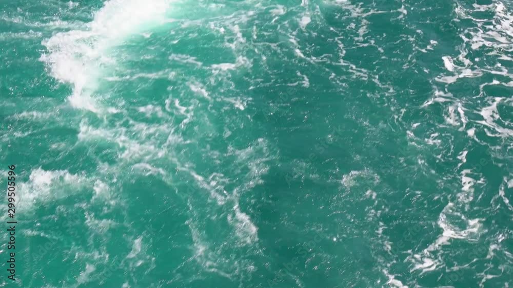Ship wake on the ocean. Water foam trace behind the large ship. Sparkle and beautiful sea waves during the daytime. footage b-roll scene 4k. Ship wake on the ocean. Water foam trace behind the large ship. Sparkle and beautiful sea waves during the daytime. footage b-roll scene 4k.