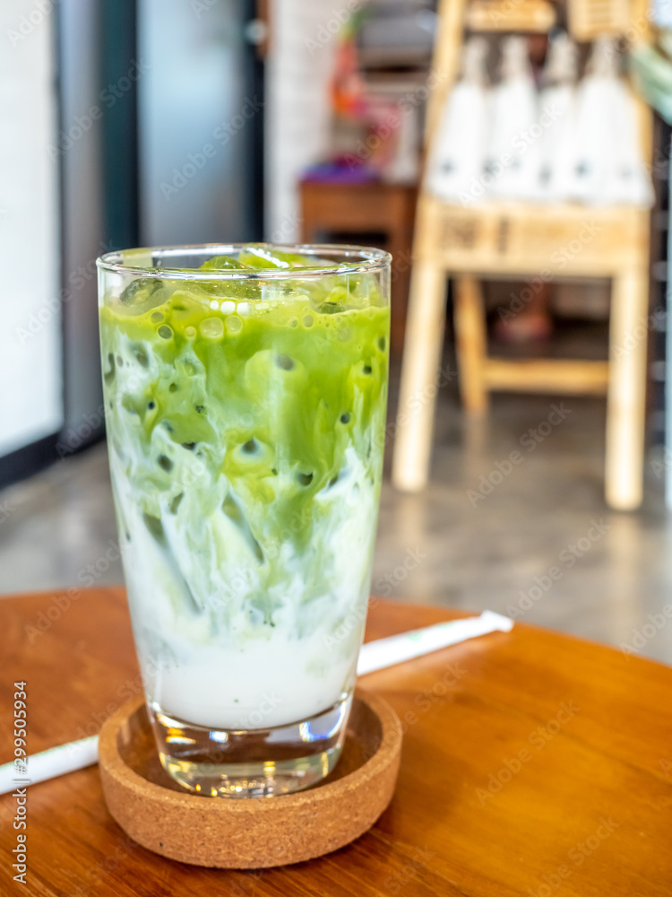 Iced green tea with milk in glass in coffee shop Iced green tea with milk in glass in coffee shop