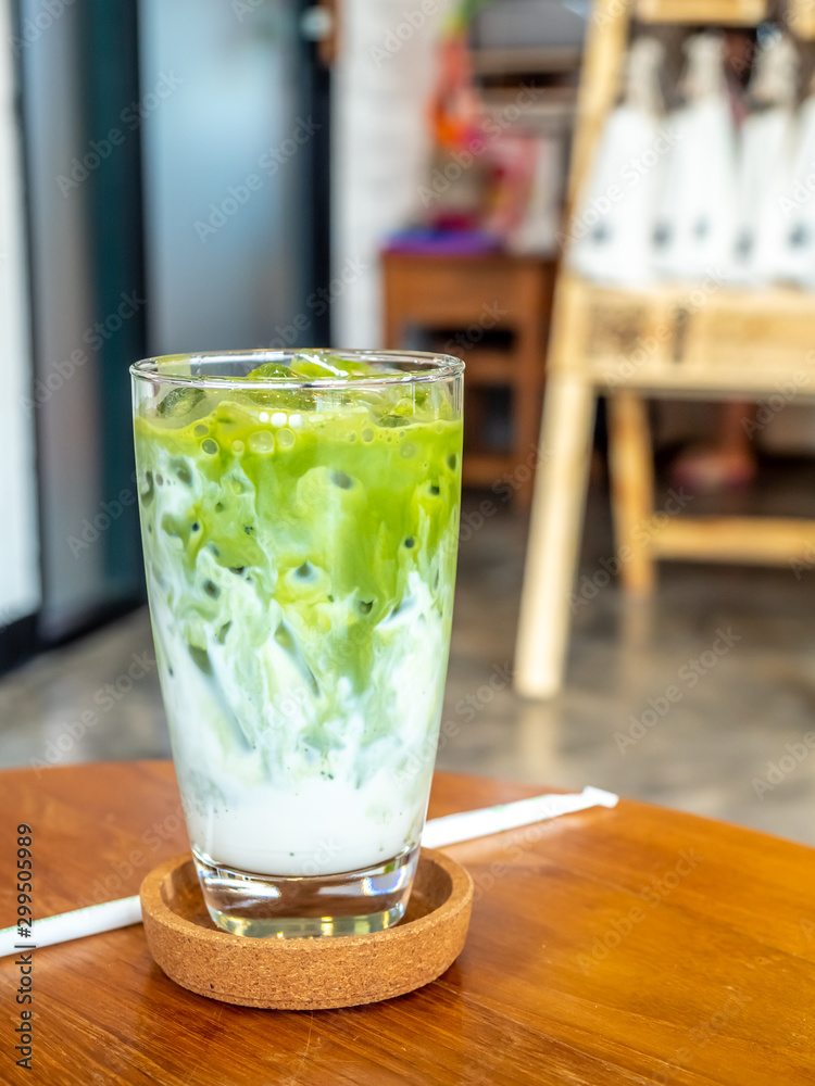 Iced green tea with milk in glass in coffee shop Iced green tea with milk in glass in coffee shop