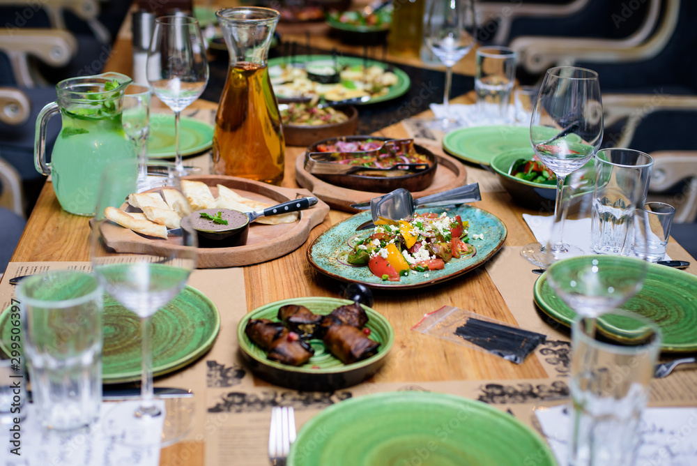 Сatering table with food and glass stemware at restaurant before party Сatering table with food and glass stemware at restaurant before party