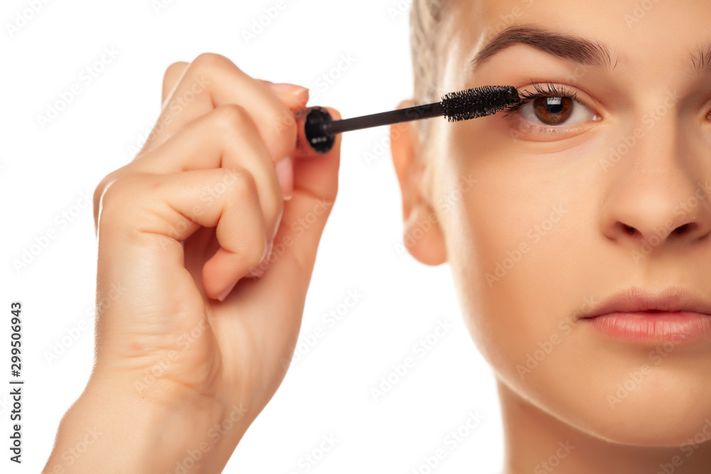 closeup of woman applyinhg mascara on her eyelashes
