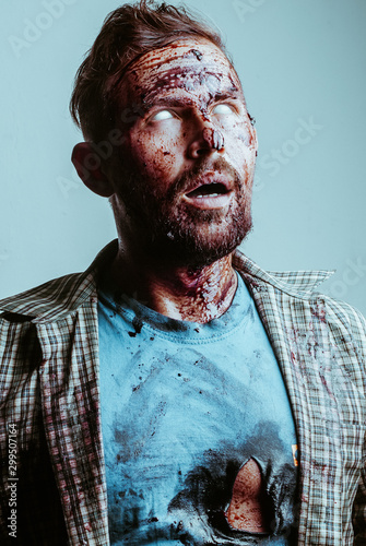 a bloody zombie face with possessed white eyes. Zombie makeup for Halloween,