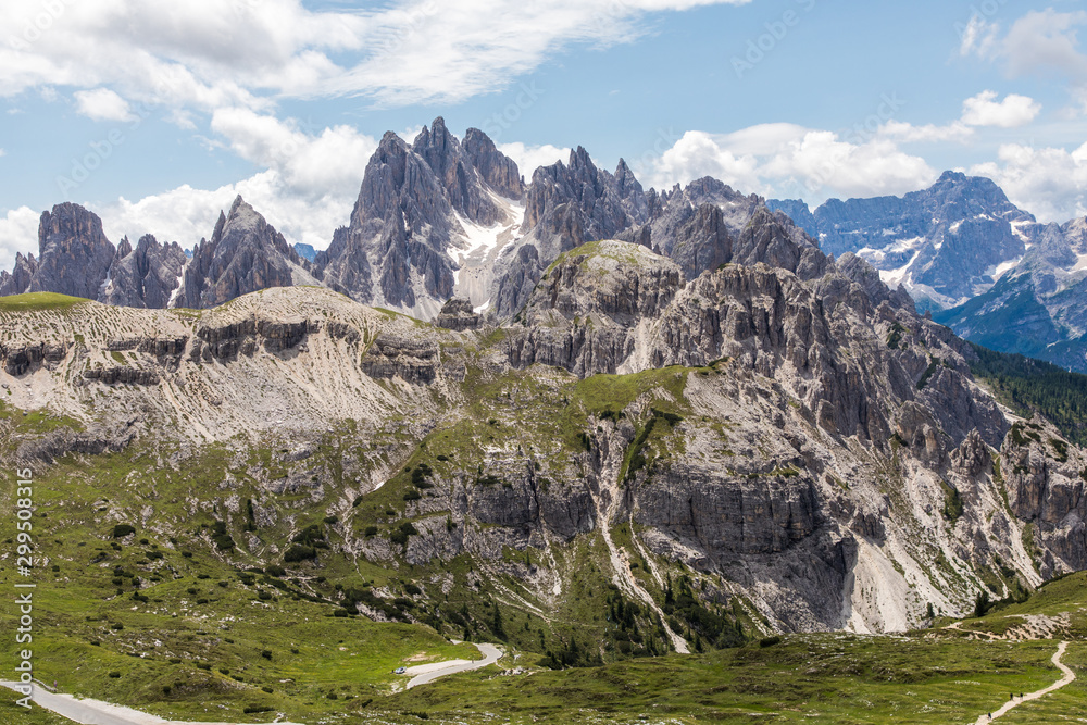 Dolomites, Italy - July, 2019: Drei Zinnen or Tre Cime di Lavaredo with beautiful flowering meadow, Sextener Dolomiten or Dolomiti di Sesto, South Tirol, Dolomiten mountains view, Italian Alps
