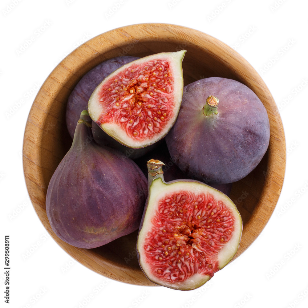Fresh purple fig fruits on wooden bowl isolated on white background. Fresh purple fig fruits on wooden bowl isolated on white background.