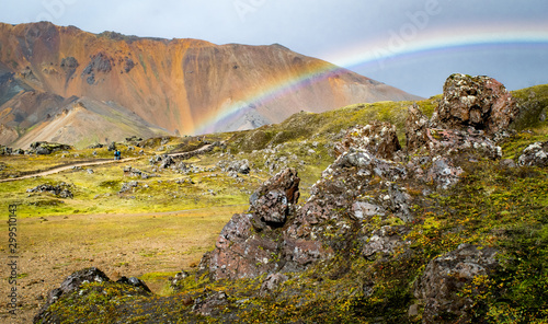 landscape with rainbow, mountain and two people