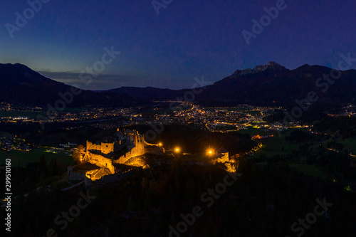 illuminated castle ruin ehrenberg at night with lightscape of reutte city
