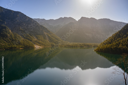fall mood at lake plansee with mountains an reflections in austria