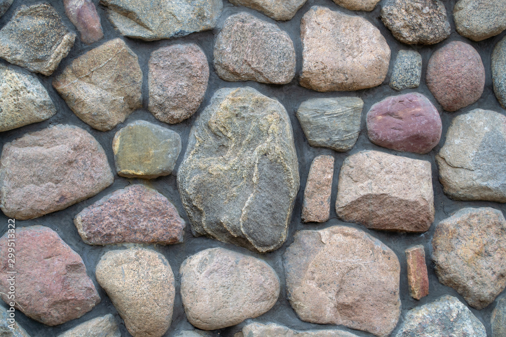 Natural big textured stone. Fragment of a colored stonewall. background. Natural big textured stone. Fragment of a colored stonewall. background.