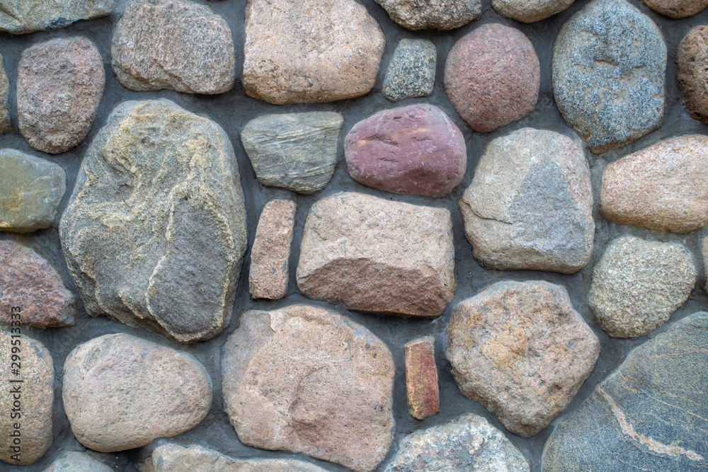 Wall background. Fragment of a colored stonewall. Natural big textured stone. Wall background. Fragment of a colored stonewall. Natural big textured stone.