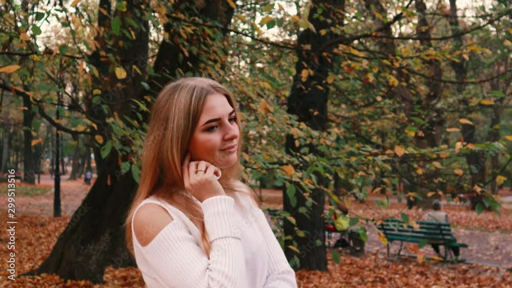 Autumn girl portraits. Model in white sweater Yellow leaves. Atmospheric video Autumn girl portraits. Model in white sweater Yellow leaves. Atmospheric video