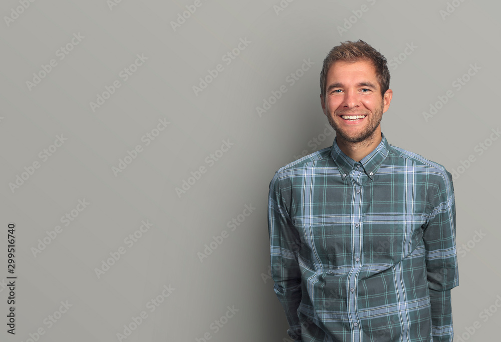 Young man in denim shirt is smiling - obrazy, fototapety, plakaty 